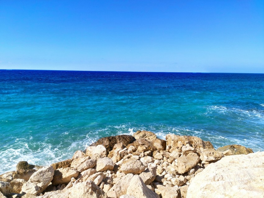 a rocky beach with waves crashing