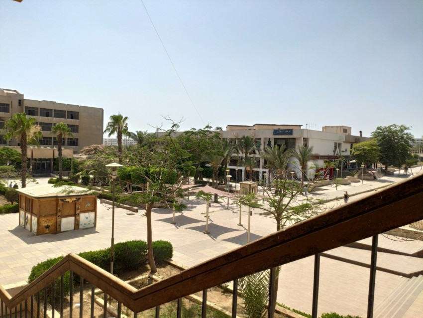 a building with trees and a fence