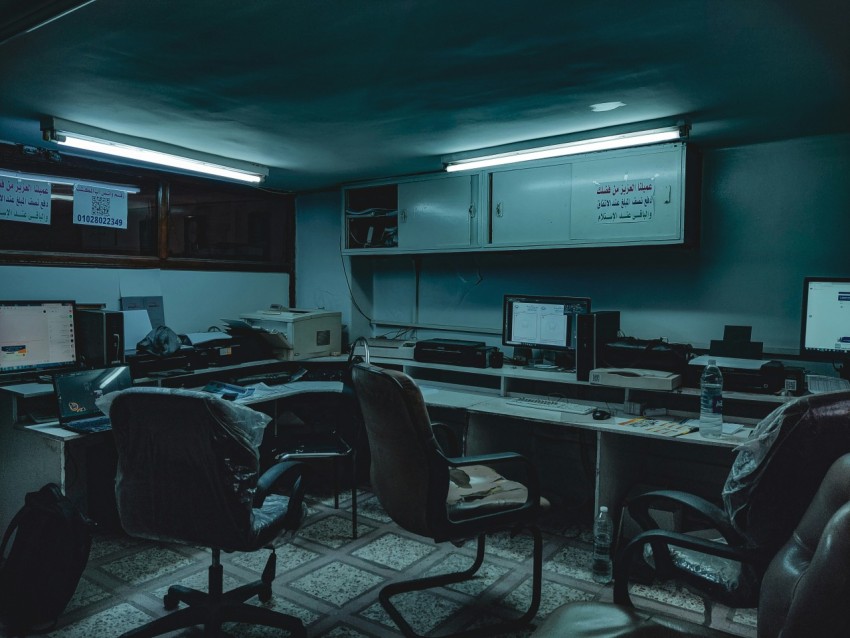 a room with computers and chairs