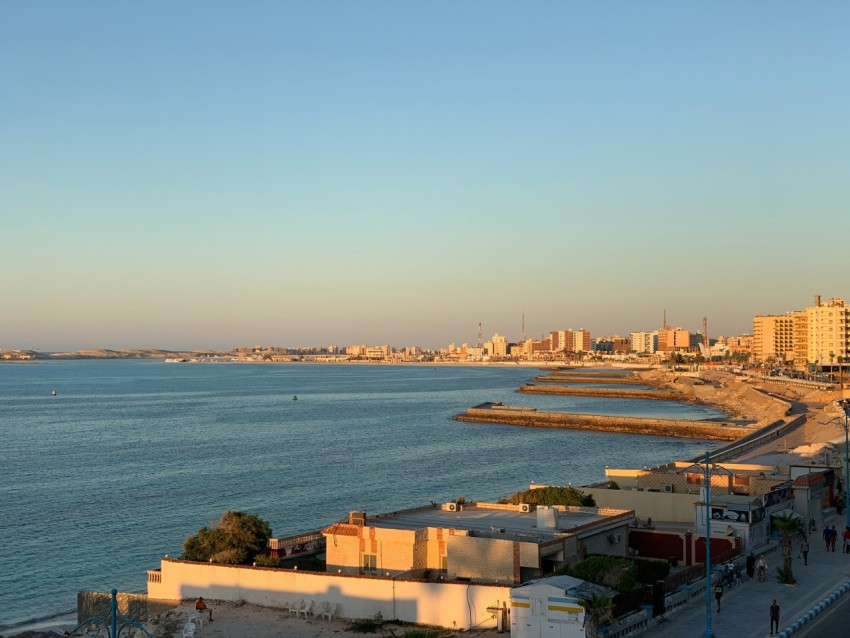 a view of a beach with a city in the background 9y