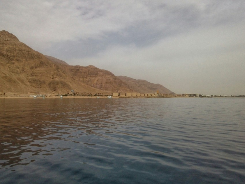 body of water under gray sky