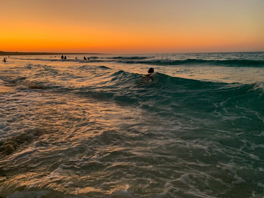 man surfing on sea waves during sunset hUKW