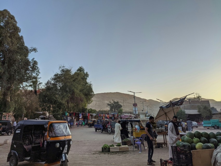 a group of people standing around a market