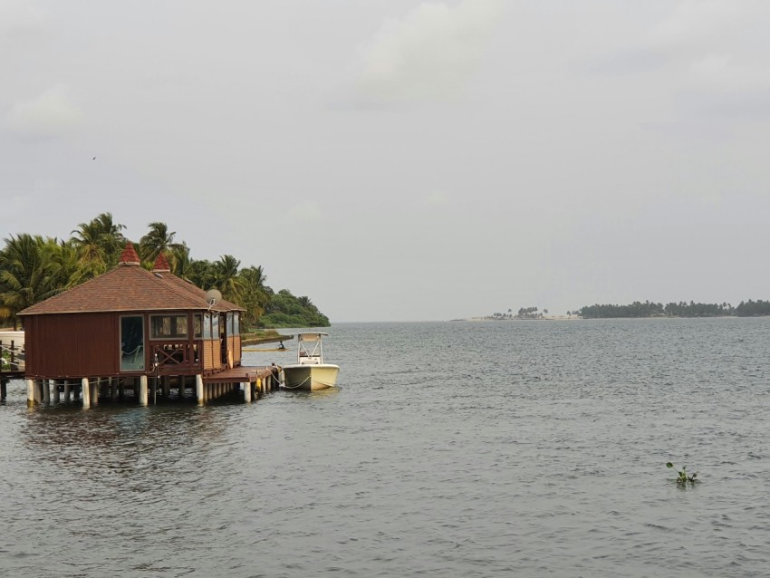 a house on a dock in the middle of the ocean