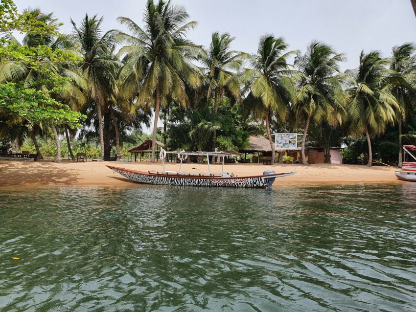 a boat sitting on top of a sandy beach