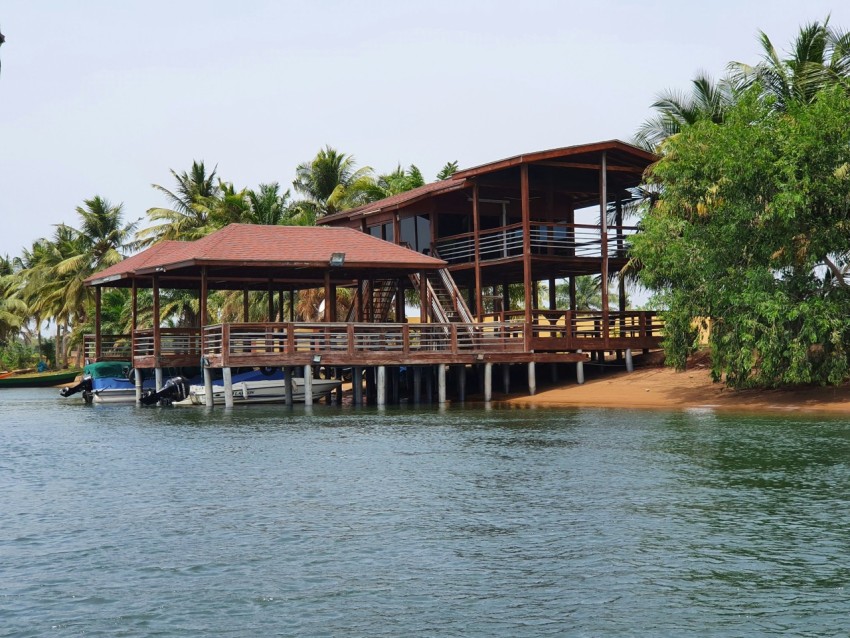 a boat dock with a house on the water