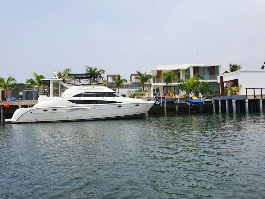 a white boat is docked in the water