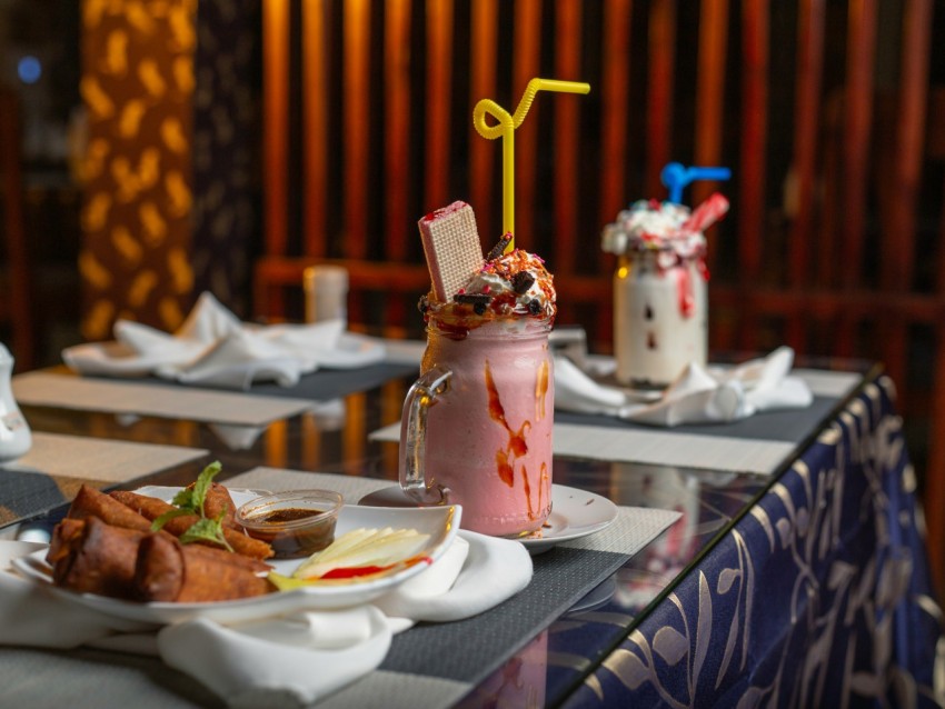 a table topped with plates of food and drinks