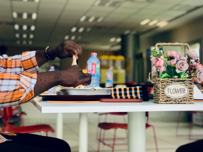 a man sitting at a table with a basket of flowers