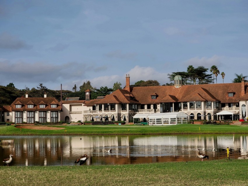 a large mansion with a lake in front of it