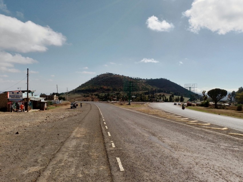 a road with a mountain in the background