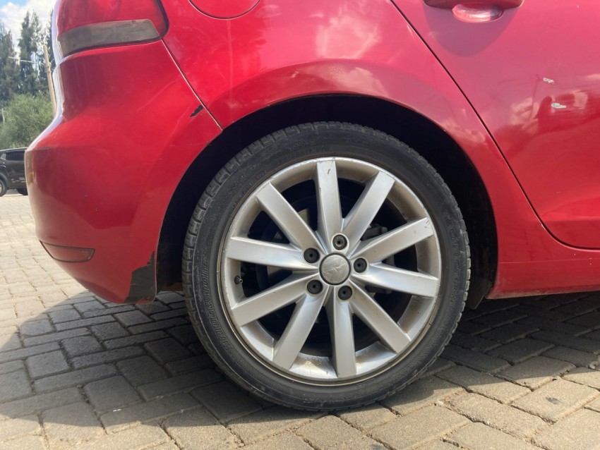 a red car parked on a brick road