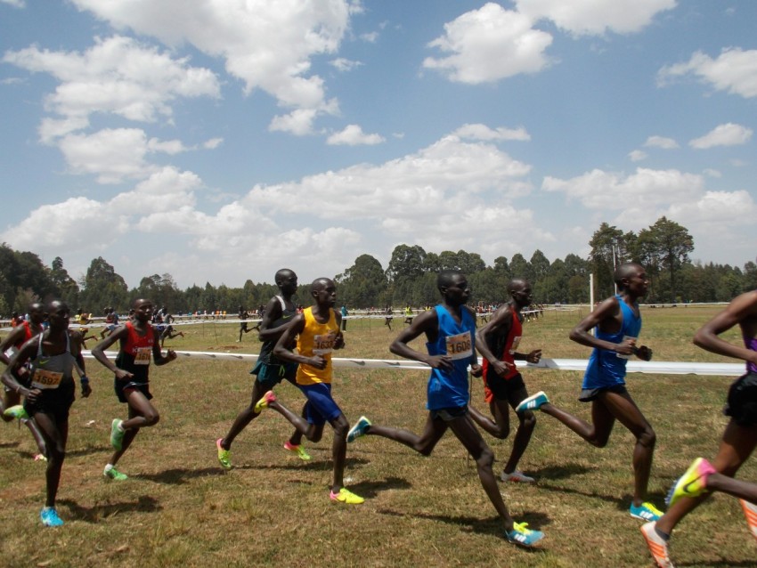 group of men running on field