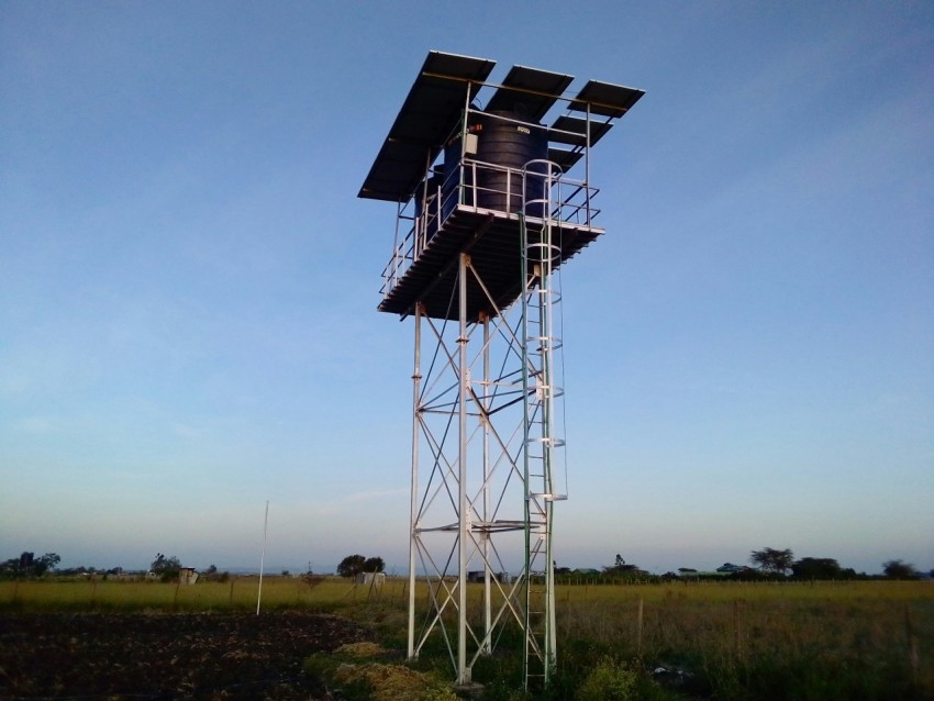 a tall metal tower with a sky background