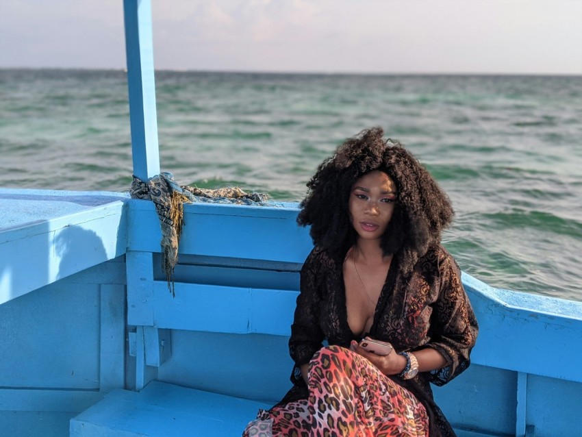 woman sitting on blue boat chair