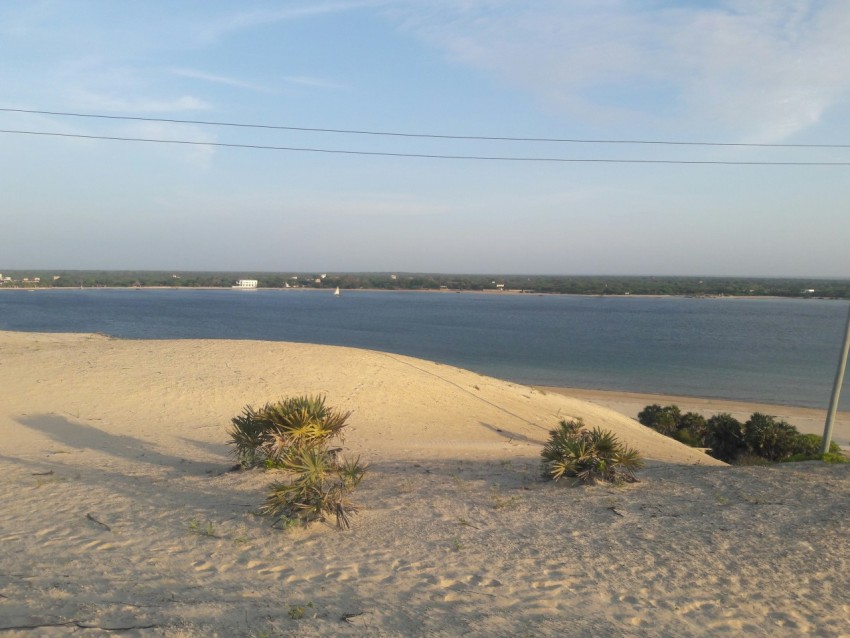 a view of a body of water from a sand dune e0