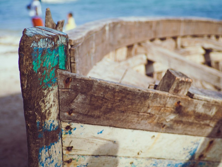 brown wooden boat on sea shore during daytime