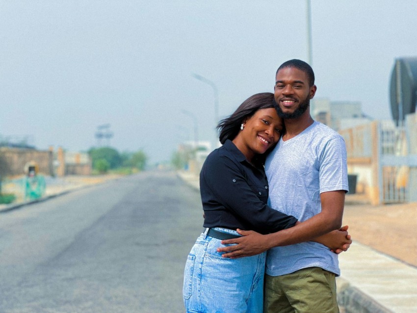 a man and a woman hugging on the side of a road 58