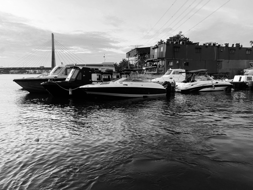 a black and white photo of boats in the water