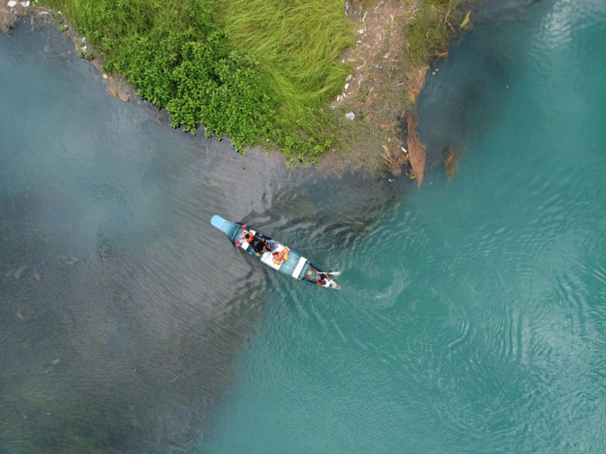 two people in a boat on a body of water 7 Y