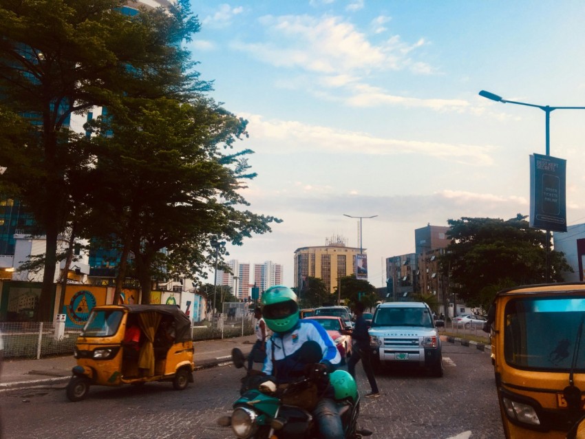 man riding on motorcycle wearing teal helmet