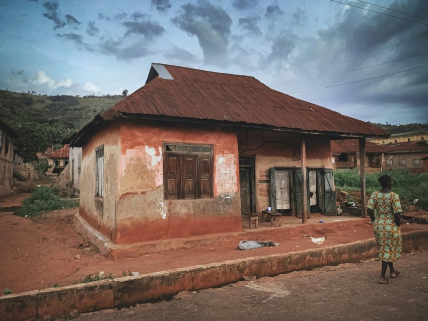 a person standing outside a house xBTBp