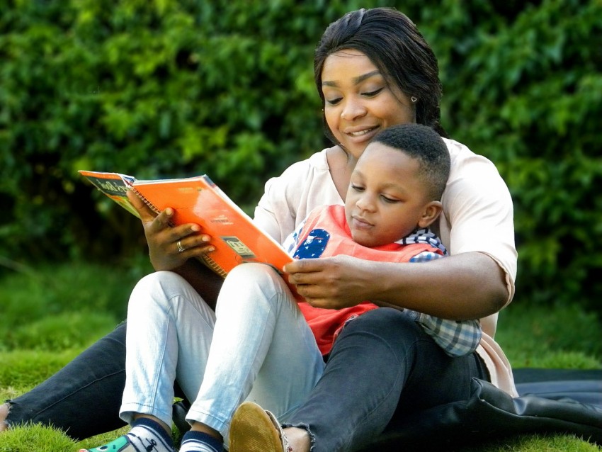 a woman reading a book to a child