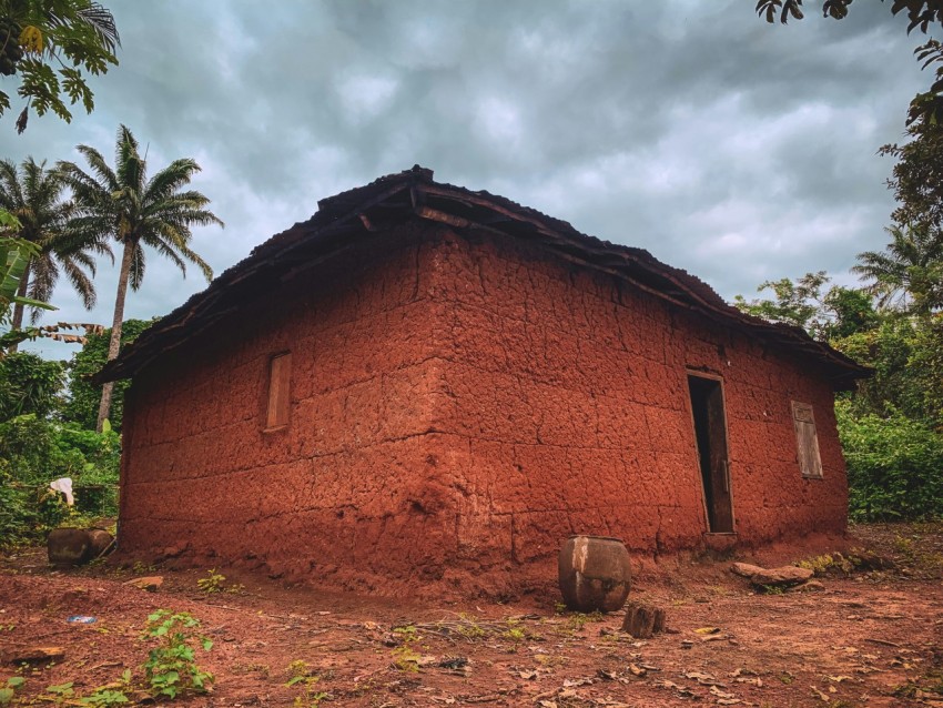 a red house with a stone roof AftbId8