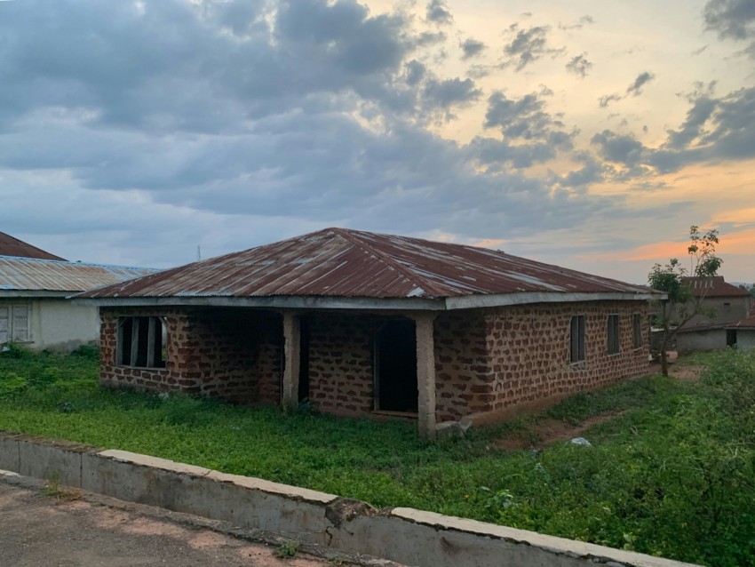 a brick building with a grass yard