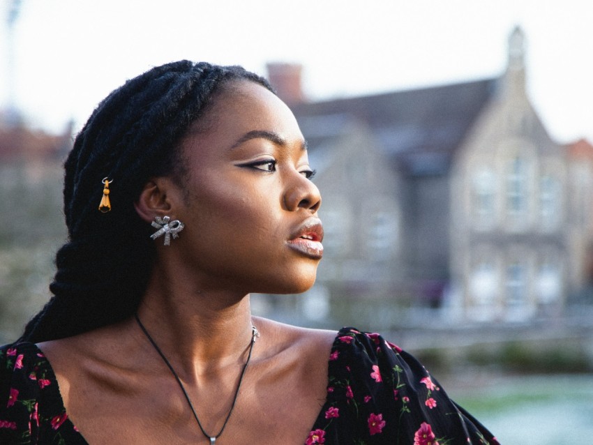 a woman with braids wearing a black dress