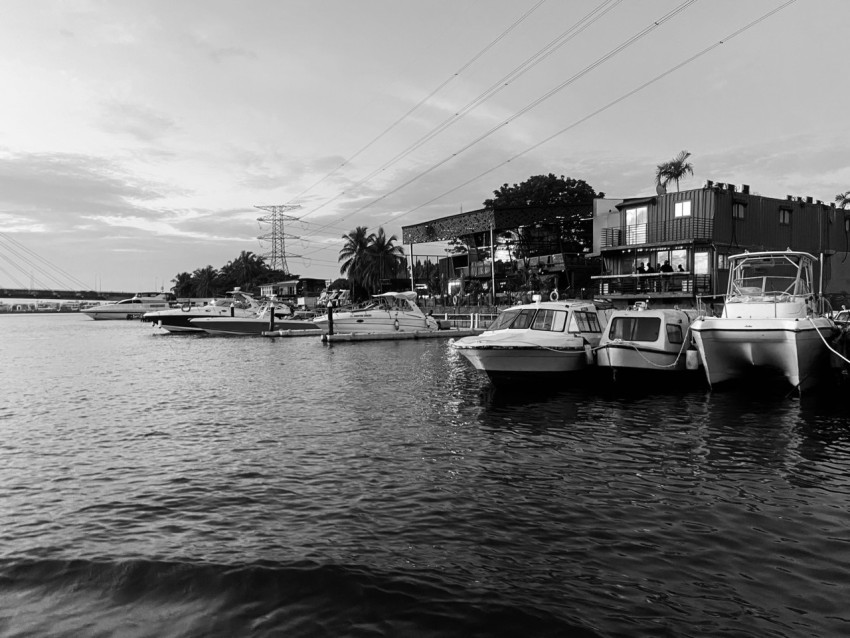 a black and white photo of boats docked in a harbor