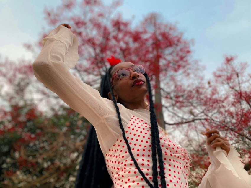 a woman in a red and white dress holding a cell phone