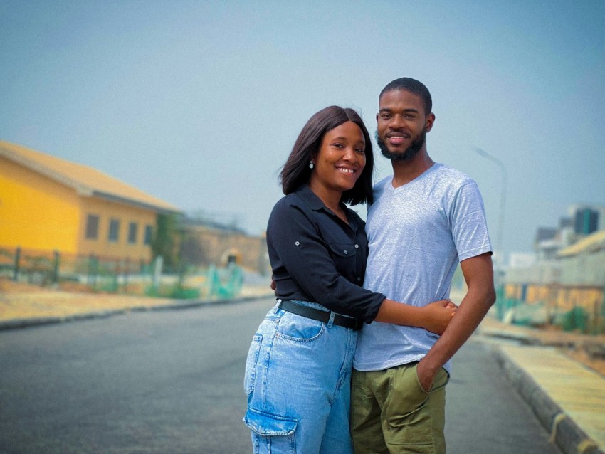 a man and a woman standing in the middle of a street