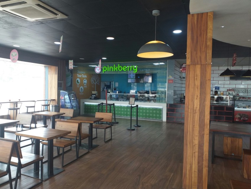 the inside of a restaurant with wooden tables and benches