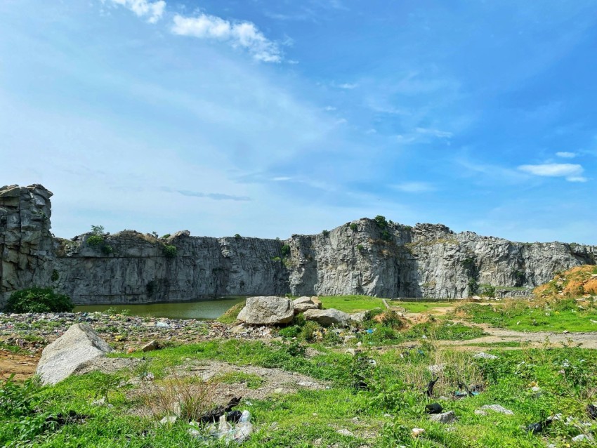 a large rock formation with a body of water in the middle of it