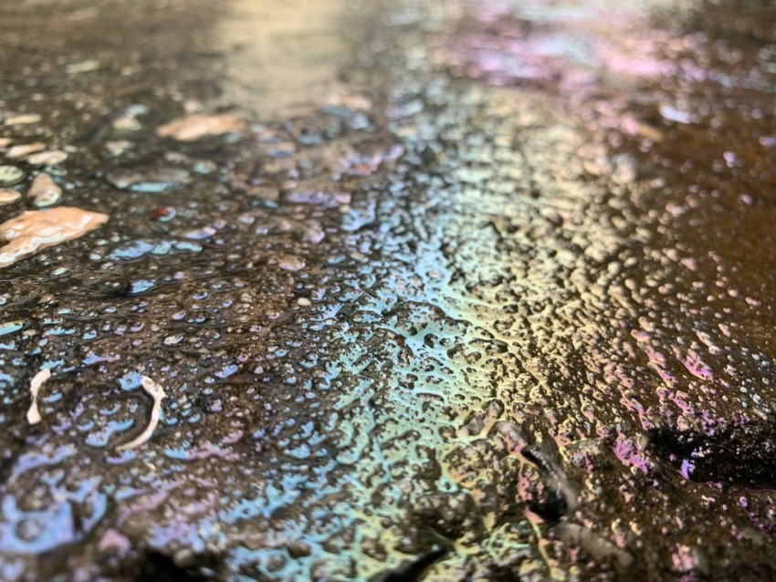 a close up of a metal surface with drops of water on it 25Q