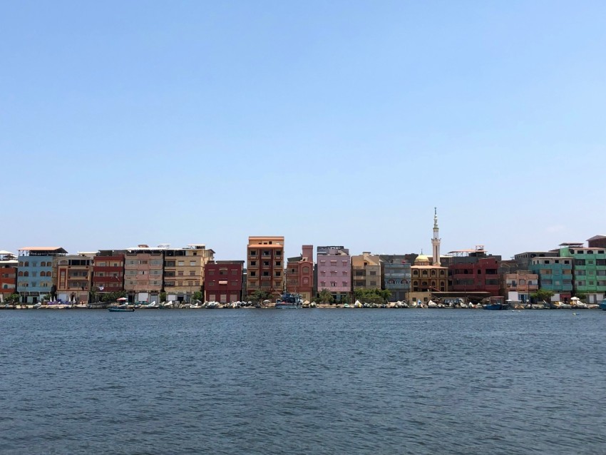 a large body of water with a city in the background M85