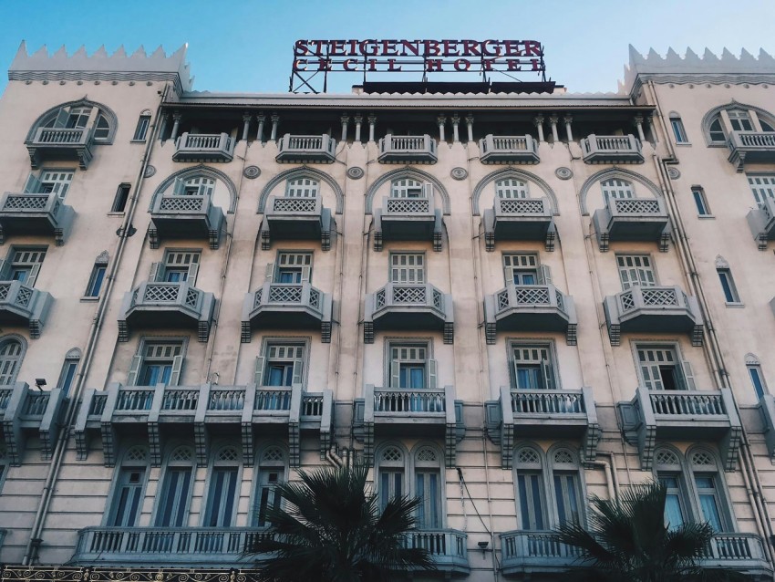 a large building with many balconies and a sign on top