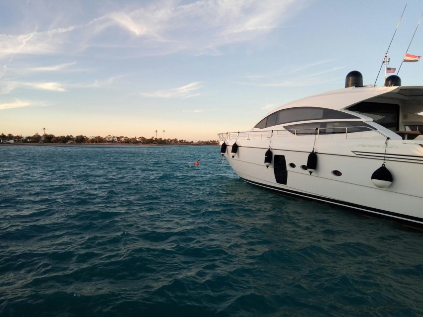 a large white boat floating on top of a body of water _