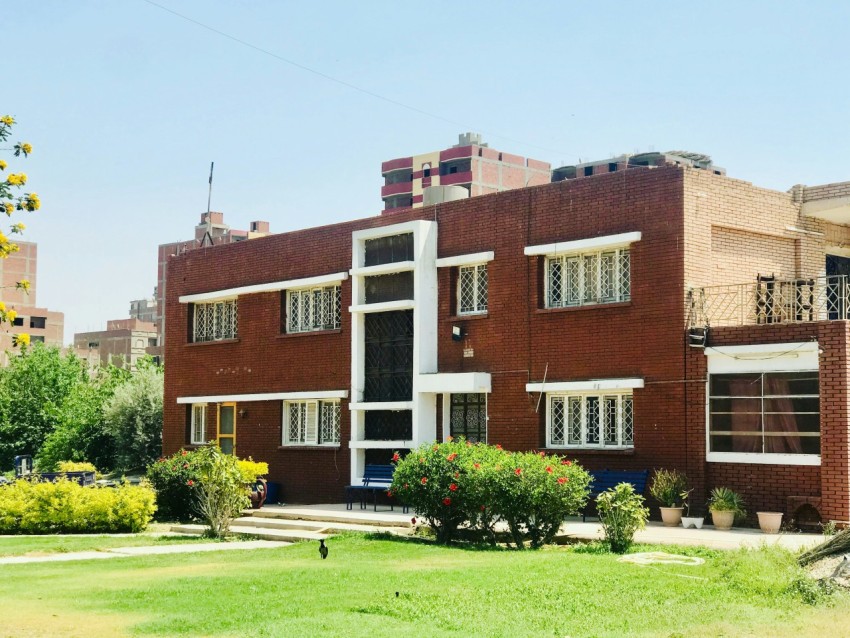 brown concrete building near green grass field during daytime