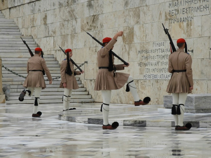 soldier wearing skirt standing infront of wall r5cW