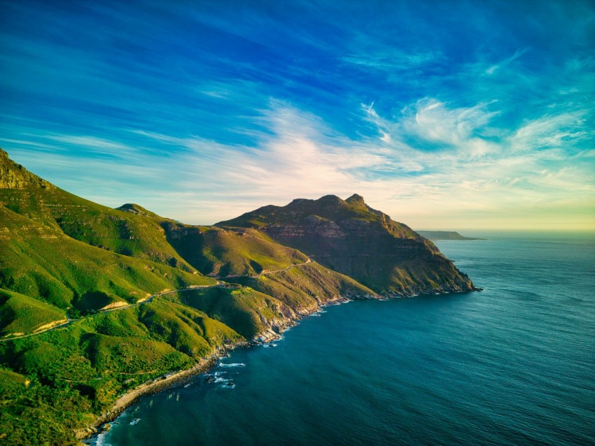 a scenic view of the ocean and mountains