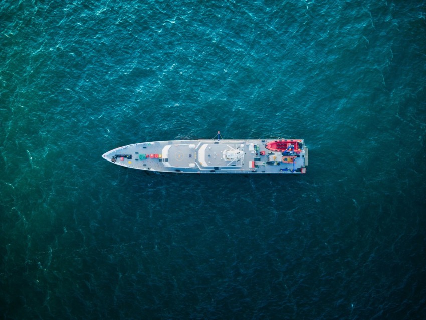 an aerial view of a boat in the ocean