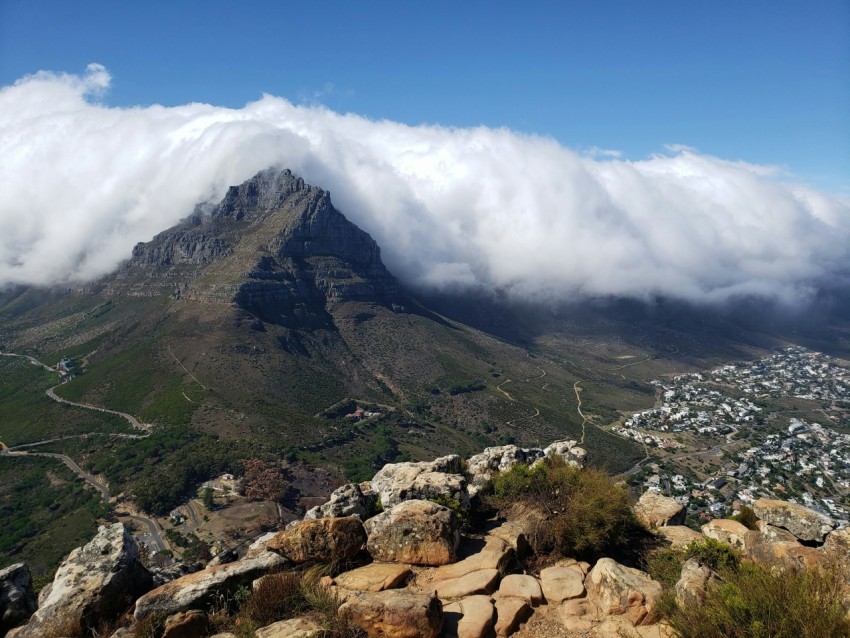 green and brown mountain under white clouds and blue sky during daytime rdt