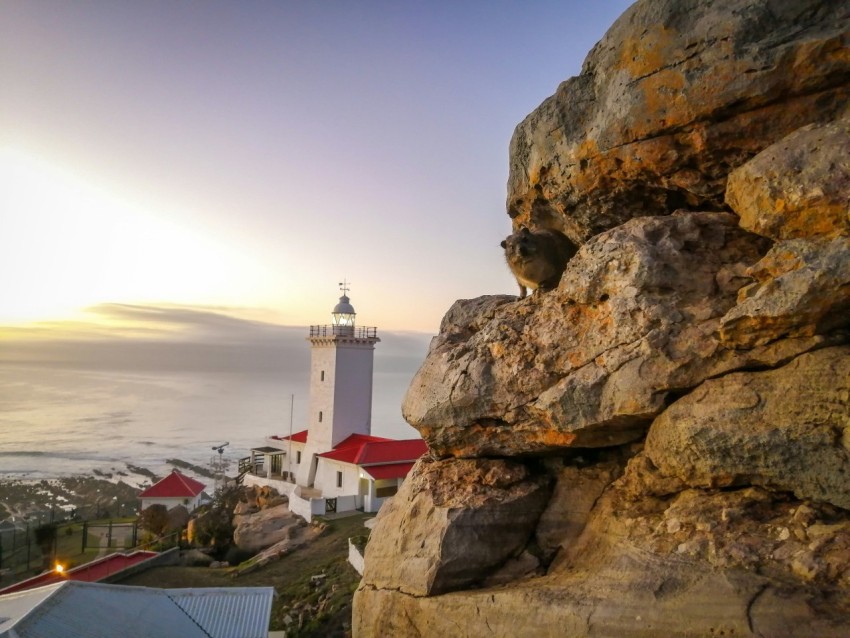 a lighthouse on top of a rocky cliff