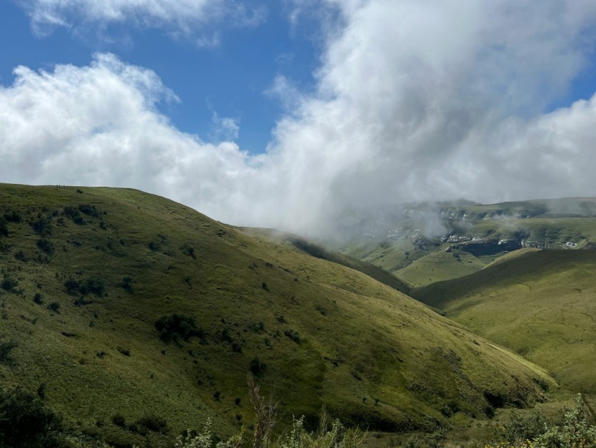 a view of a mountain range with clouds in the sky