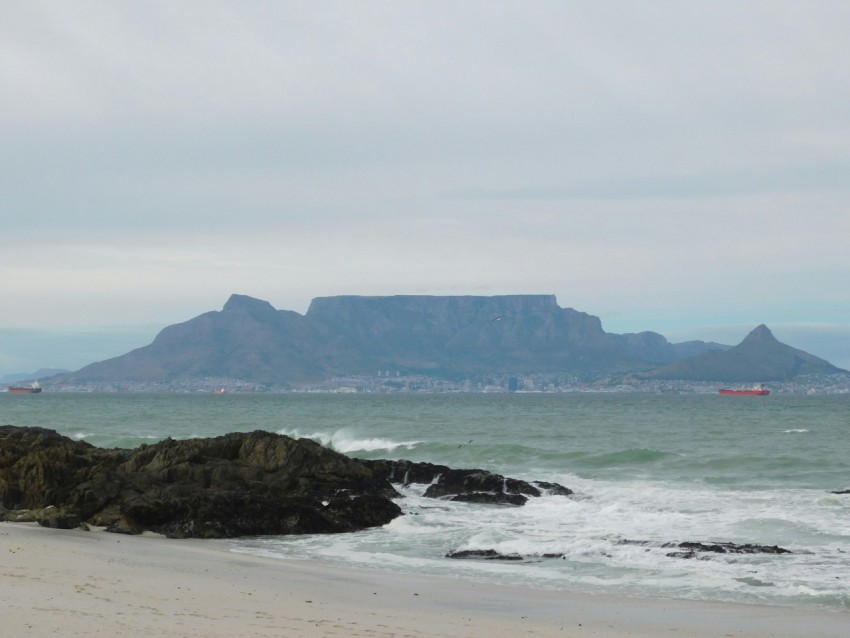 a view of a beach with a mountain in the background