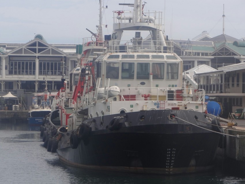 a large boat docked in a harbor next to a building z