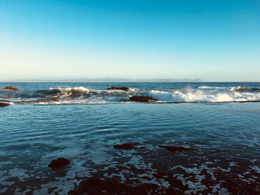 ocean waves crashing on shore during daytime