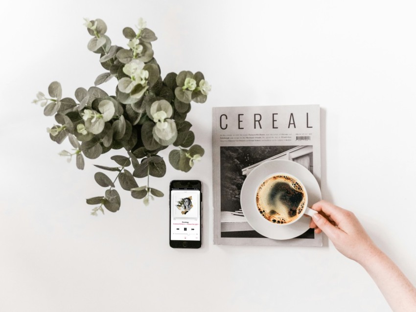 flat lay photography of smartphone newspaper and teacup